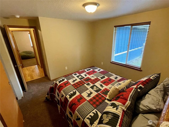 carpeted bedroom featuring a textured ceiling