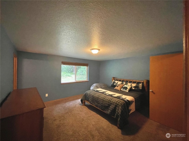 bedroom with carpet floors and a textured ceiling