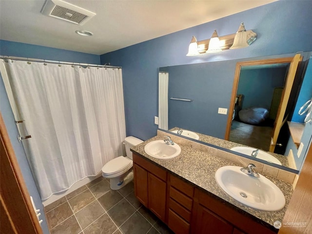 bathroom featuring visible vents, a sink, and toilet