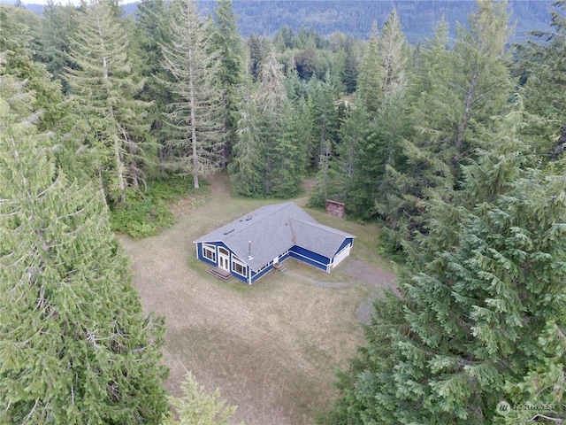 aerial view featuring a wooded view