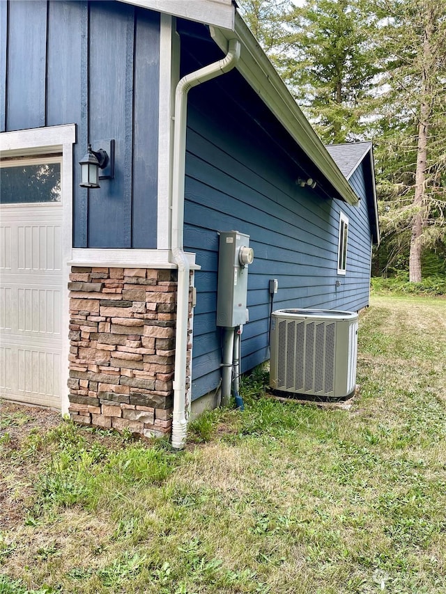 view of home's exterior featuring cooling unit and a yard