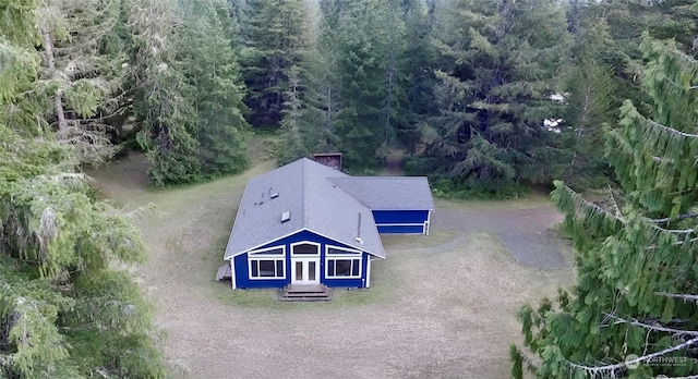 birds eye view of property with a view of trees