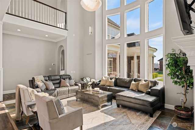 living room with a high ceiling and ornamental molding