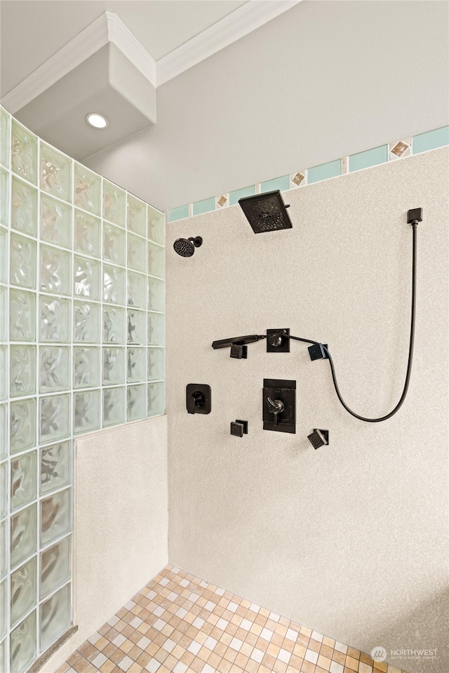 bathroom with tiled shower and ornamental molding