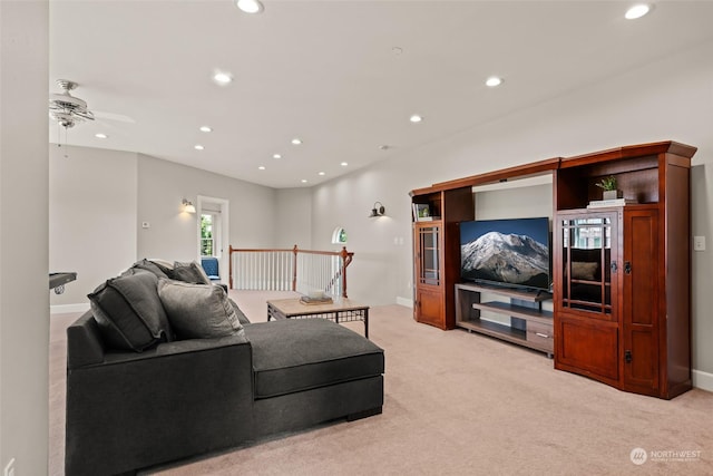 carpeted living room with ceiling fan