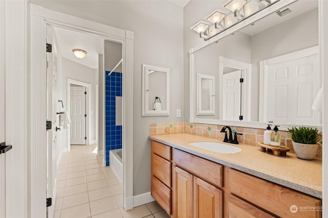 bathroom with tile patterned floors, vanity, and  shower combination