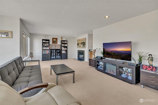 living room featuring light carpet and a textured ceiling