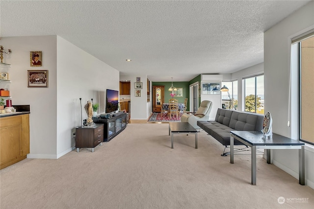 living room featuring light carpet and a textured ceiling