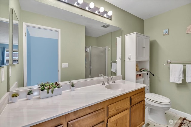 bathroom featuring vanity, toilet, and a shower with door