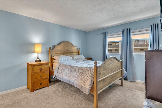 carpeted bedroom featuring a textured ceiling