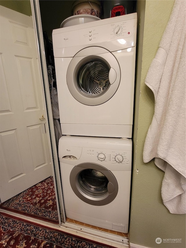 clothes washing area with stacked washer and clothes dryer