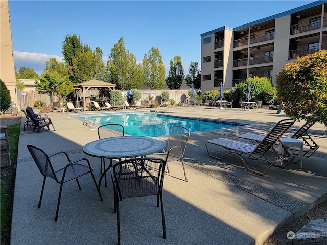 view of swimming pool featuring a gazebo and a patio area