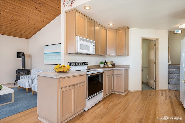 kitchen with light brown cabinetry, white appliances, light hardwood / wood-style floors, wooden ceiling, and a wood stove