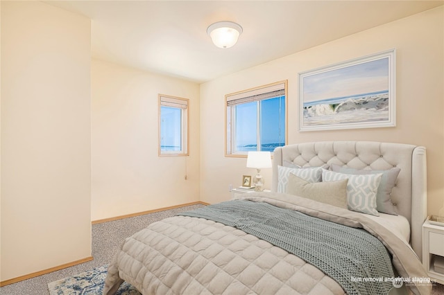 carpeted bedroom featuring baseboards