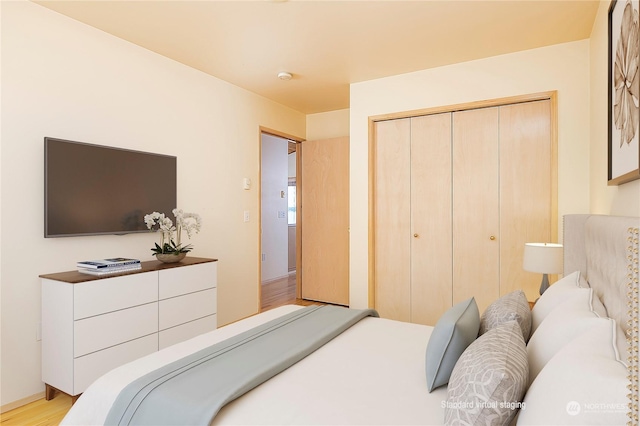 bedroom featuring light wood-type flooring and a closet