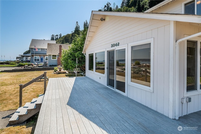 wooden deck featuring a yard