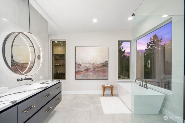 bathroom featuring vanity, vaulted ceiling, and tile patterned flooring