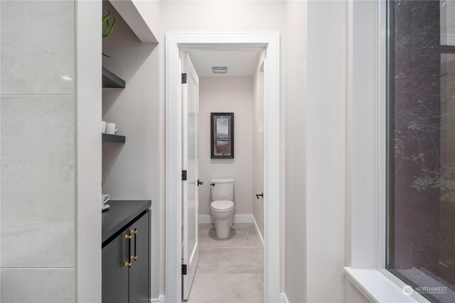 bathroom with tile patterned floors, vanity, and toilet