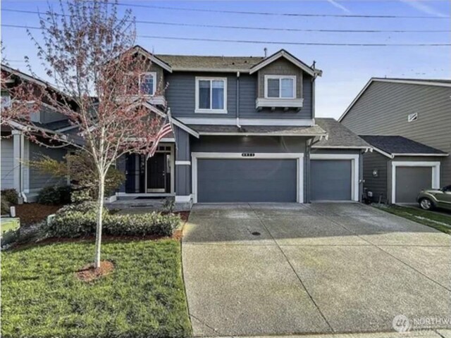 8022 175th Street Ct E, Puyallup, WA 98375 - view of front facade with a shingled roof, driveway, a garage, and a front lawn