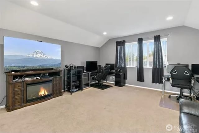 carpeted home office featuring lofted ceiling