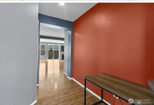 hallway with wood-type flooring