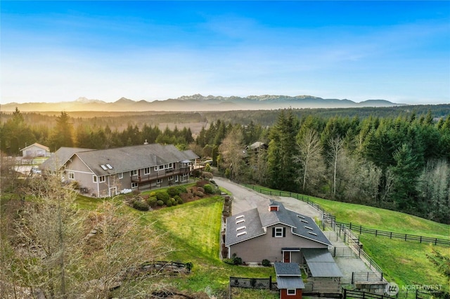 birds eye view of property featuring a mountain view and a wooded view