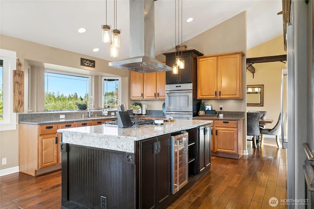 kitchen with wine cooler, island exhaust hood, dark wood finished floors, stainless steel appliances, and vaulted ceiling