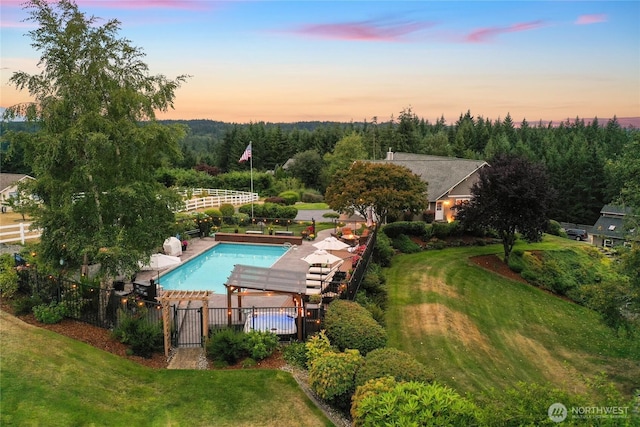 view of pool featuring fence, a fenced in pool, and a yard