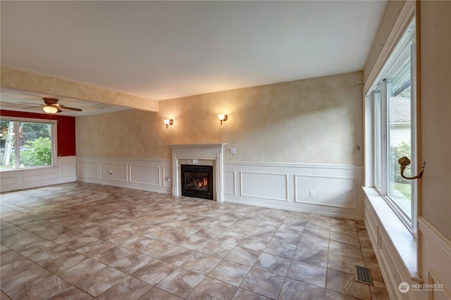 unfurnished living room featuring ceiling fan