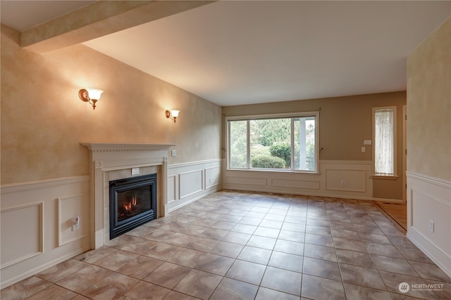 unfurnished living room featuring light tile patterned floors