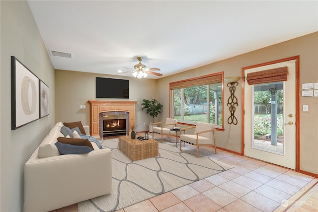 living room with light tile patterned floors and ceiling fan