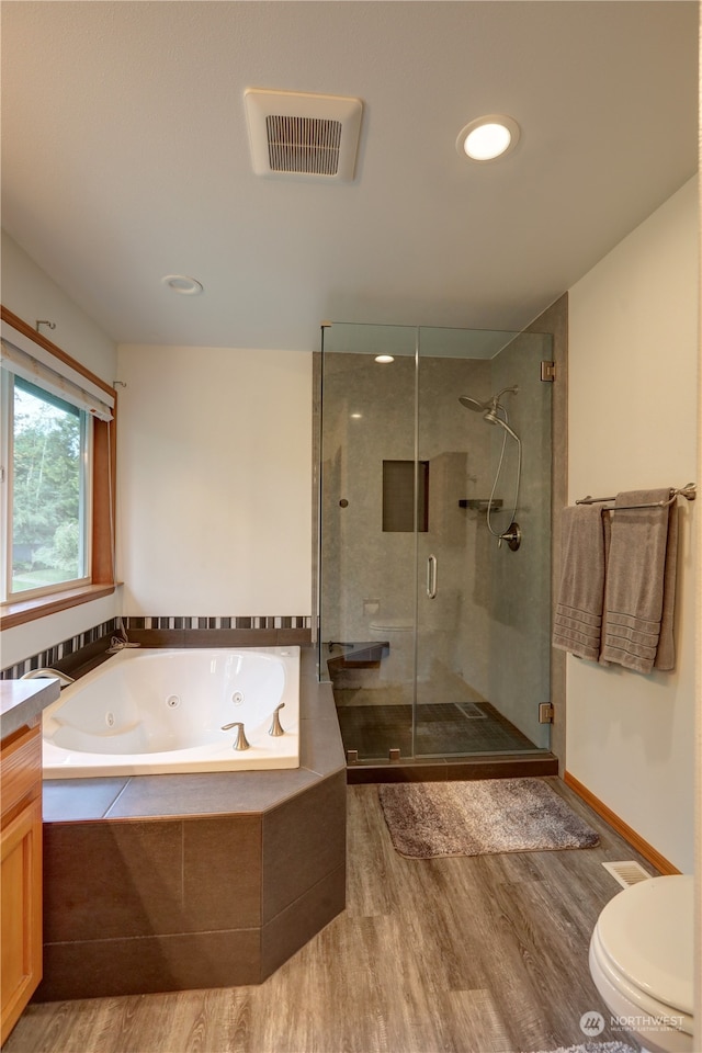 full bathroom with toilet, vanity, plus walk in shower, and wood-type flooring