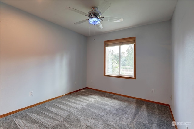 carpeted spare room featuring ceiling fan