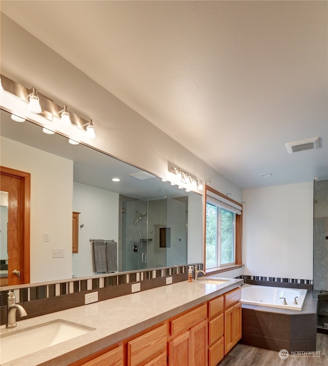 bathroom with vanity, shower with separate bathtub, and hardwood / wood-style flooring