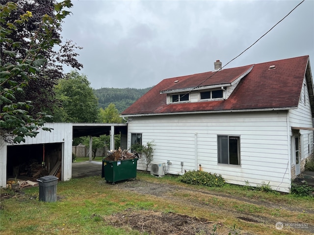 rear view of property featuring cooling unit