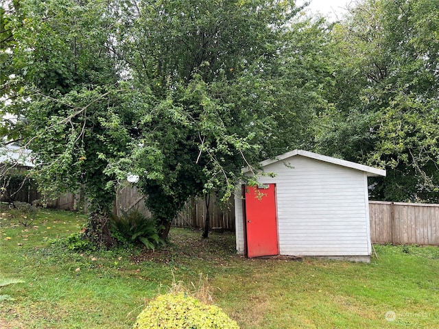 view of outdoor structure featuring a lawn