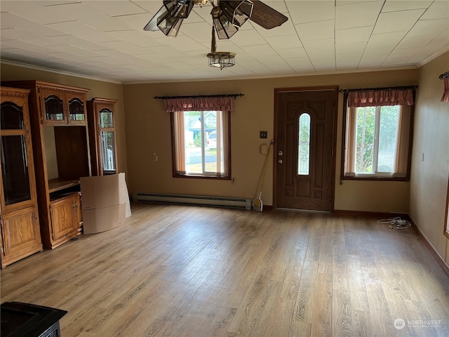 entryway featuring ceiling fan, plenty of natural light, hardwood / wood-style flooring, and a baseboard radiator