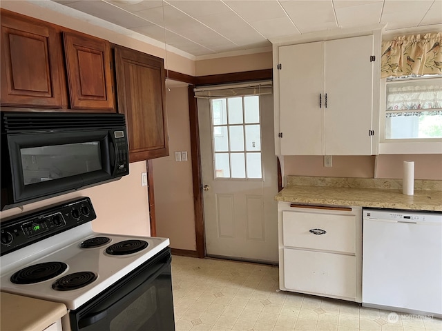 kitchen with white cabinets, white appliances, and light tile patterned floors