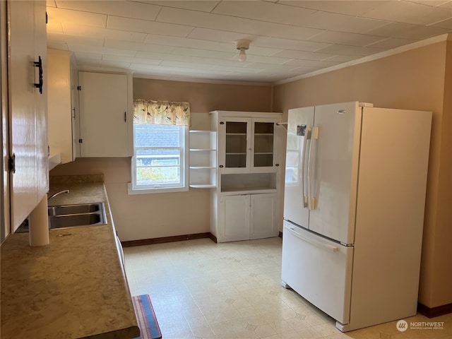 kitchen with white refrigerator, light tile patterned flooring, and sink