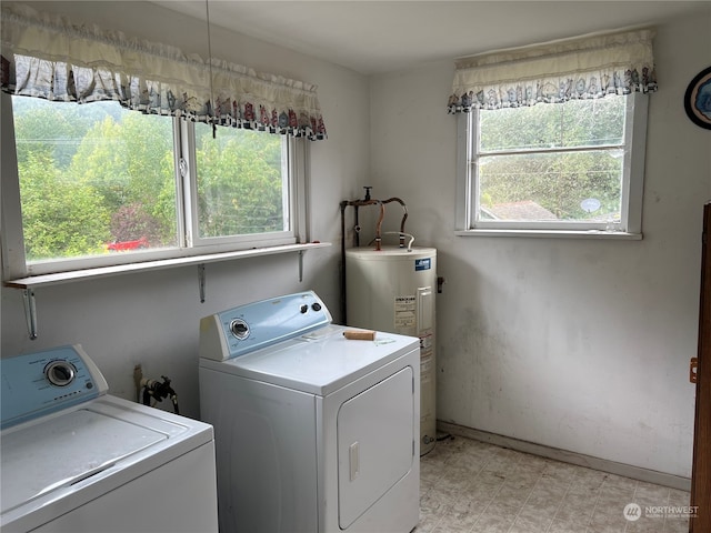 washroom with water heater, light tile patterned floors, and washer and clothes dryer