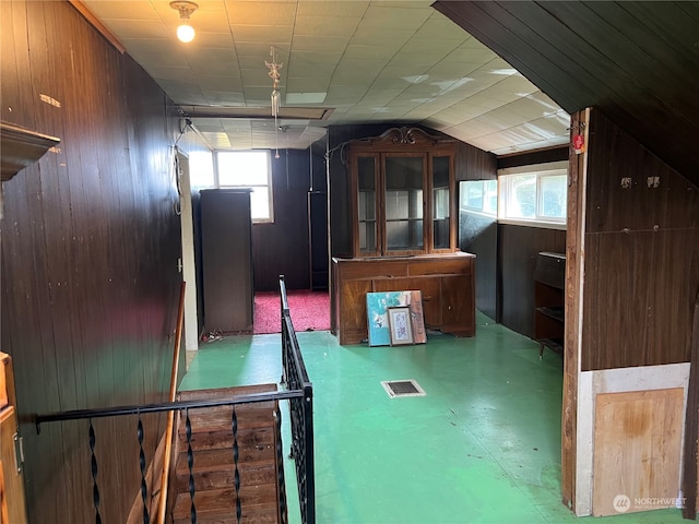 additional living space featuring wood walls