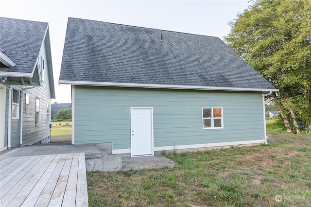 rear view of property featuring a wooden deck