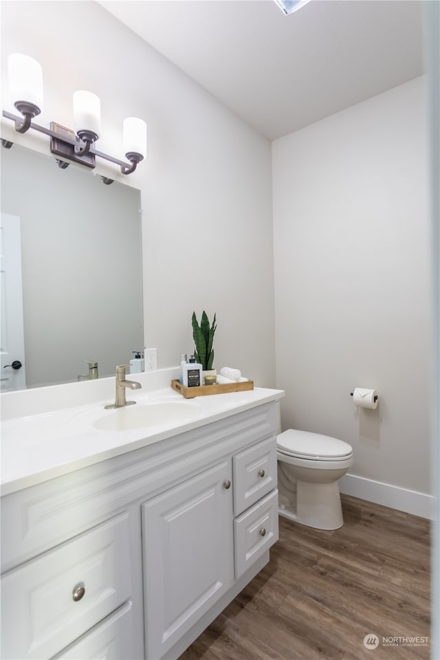 bathroom featuring hardwood / wood-style floors, toilet, and vanity