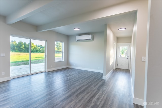 interior space featuring a wall mounted AC, beamed ceiling, and dark hardwood / wood-style floors