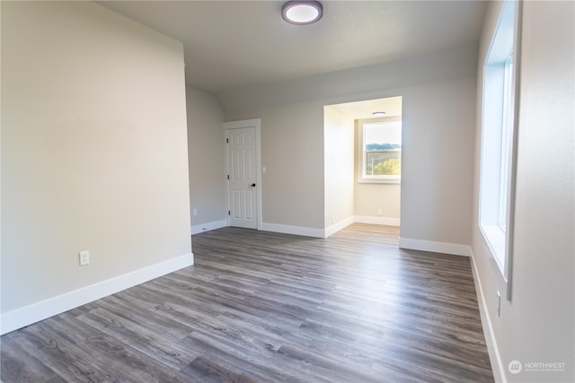 unfurnished room with wood-type flooring