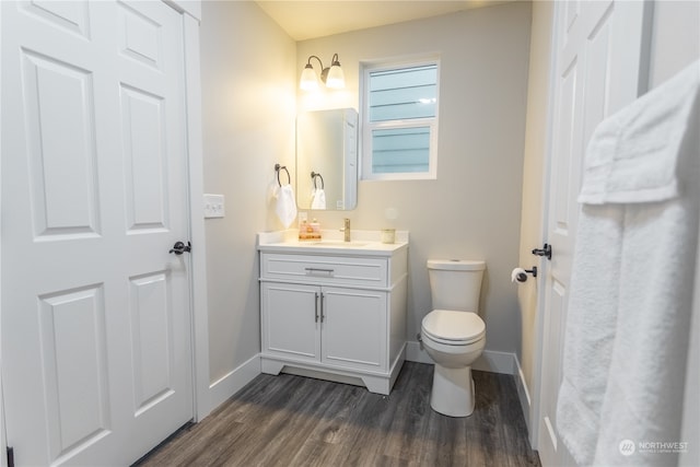 bathroom featuring hardwood / wood-style floors, toilet, and vanity