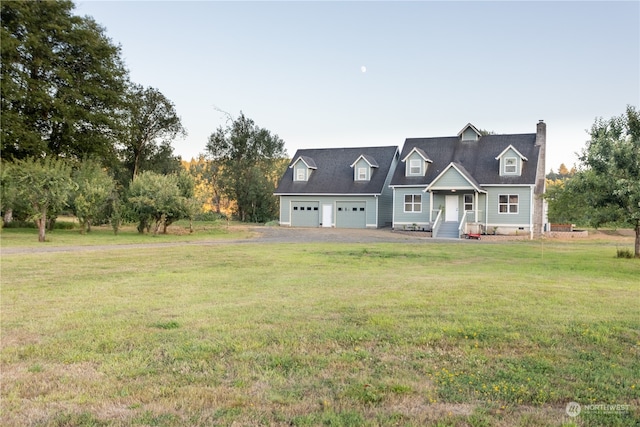 new england style home featuring a garage and a front yard