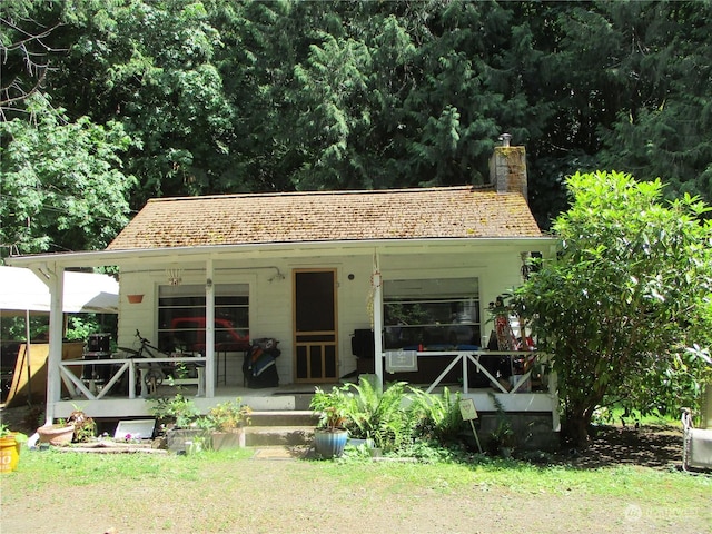 back of property with covered porch