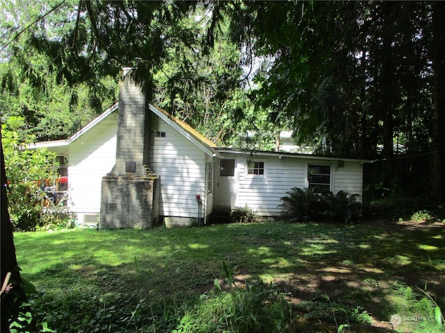 rear view of property featuring a yard