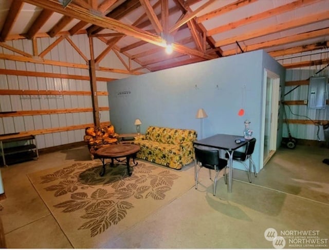 interior space with electric panel and concrete flooring